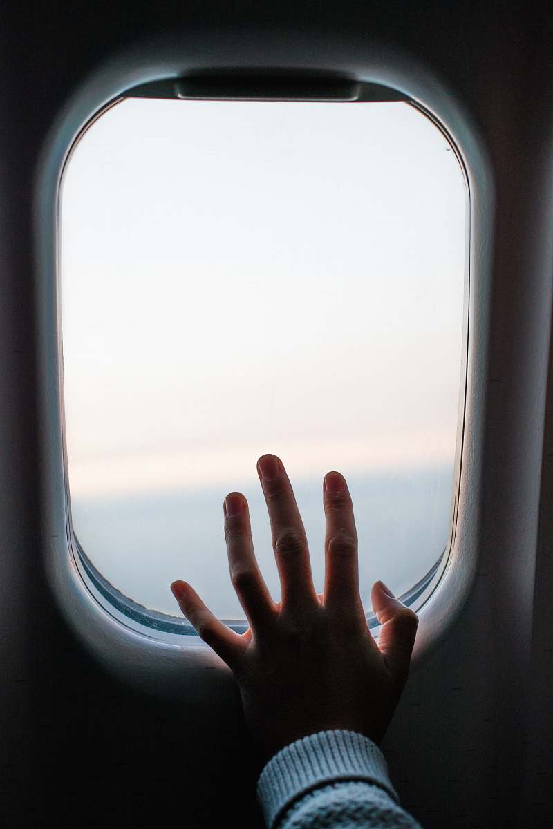car mirror person touching airplane window mirror